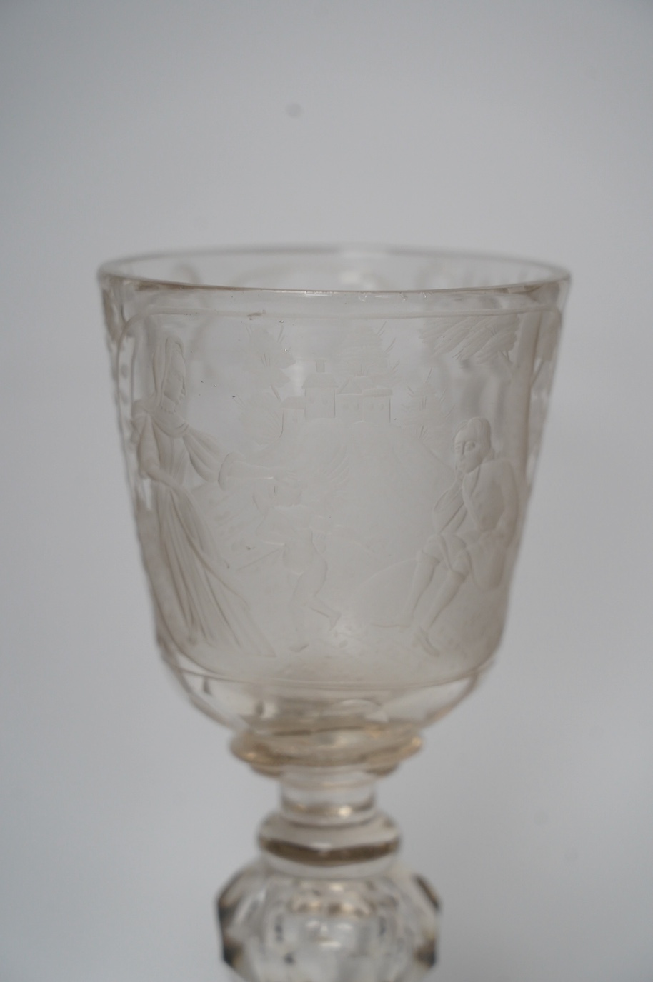 A Victorian engraved tall stemmed wine glass with white metal mounted foot rim, 22cm high. Condition - fair to good